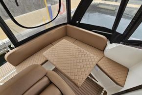 Luxurious seating area on 2023 Balt 818 Titanium boat with quilted cushions and table.