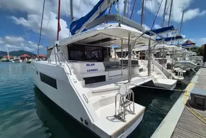 Leopard 45 catamaran docked at marina, 2021 model, sunny day, blue sky.