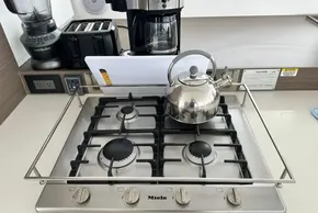 Modern kitchen with Miele gas stove, kettle, and appliances on Leopard 46 Powercat yacht.
