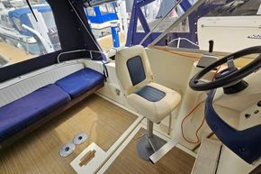 Interior of 1985 Fairline Mirage 29 boat with seating and steering area.
