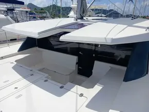 2019 Leopard 45 catamaran deck with seating and storage, docked at marina.