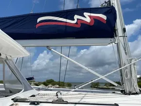 Leopard 50 sailboat, 2020 model, with blue sail cover and scenic ocean backdrop.