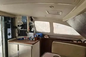 Interior of a 2008 Leopard 38 catamaran with navigation equipment and seating area.
