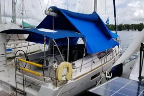 2013 Beneteau Oceanis 41 sailboat docked with blue canopy and solar panel.