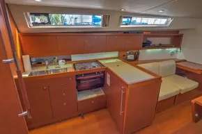 Interior of 2013 Beneteau Oceanis 41 yacht, featuring a modern kitchen and seating area.