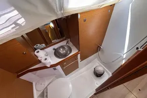 Modern bathroom interior of 2020 Jeanneau Sun Odyssey 389 yacht, featuring sink and shower.