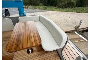 2025 Linssen 45 SL Sedan yacht with elegant wooden deck and seating area.