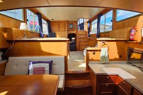 Interior of 2005 Stevens 1200 Vlet boat with wooden furnishings and natural light.