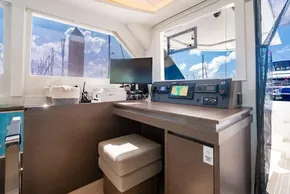 Modern navigation station on a 2022 Leopard 50 yacht with electronic equipment and seating.