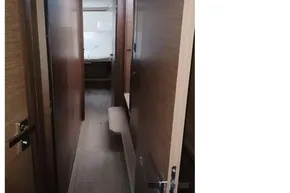 Interior hallway of 2020 Lagoon 46 yacht with wooden finish.