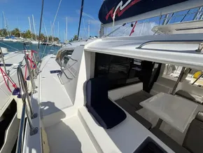 2019 Leopard 40 catamaran docked, featuring spacious deck and seating area under clear blue sky.