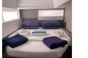 Luxurious cabin interior of 2022 Leopard 45 yacht with neatly arranged bedding.