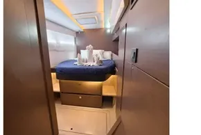 Luxurious cabin interior of 2021 Leopard 50 yacht with elegant bedding and ambient lighting.