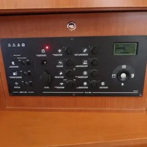 Control panel of 2019 Beneteau Oceanis 41.1 yacht, featuring various switches and display.