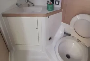 Beneteau Oceanis 46.1 2020 yacht bathroom with sink, mirror, and toilet.