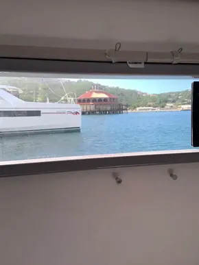 View from inside a 2020 Leopard 40 yacht, overlooking a marina and waterfront building.
