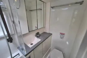 Modern bathroom in a 2020 Leopard 45 yacht, featuring sleek fixtures and mirrored cabinets.