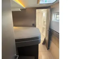 Modern interior cabin of 2025 Leopard 46 yacht, featuring a cozy bed and sleek design.