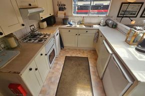 Cozy kitchen interior on a 1926 Dutch Barge Luxemotor, featuring modern appliances and ample counter space.