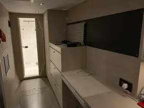 Interior of a 2020 Leopard 40 catamaran with modern cabinetry and a view of the bathroom.