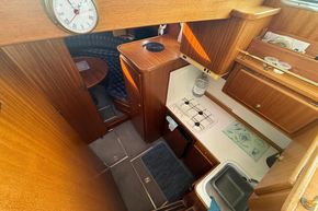 Interior of 1994 Linssen 360 AC yacht, featuring a compact kitchen and dining area.