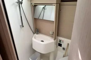 Modern bathroom in 2023 Beneteau Oceanis 51.1 yacht, featuring sleek sink and shower.
