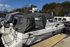1991 Sealine 290 Ambassador boat docked, featuring a covered cockpit and sleek design.