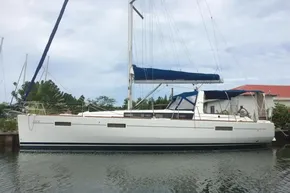2013 Beneteau Oceanis 41 sailboat docked, featuring sleek design and blue sail cover.