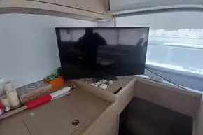Interior of 2024 Lagoon 42 yacht with TV and decorative items.