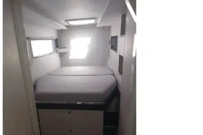 Cozy cabin interior of 2018 Leopard 45 yacht with bed and window.