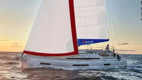 2019 Jeanneau Sun Odyssey 440 sailing at sunset on open sea.