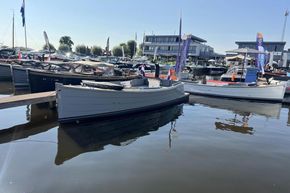 Enkhuizensloep 680 Tender 2026 docked at marina, surrounded by other boats.