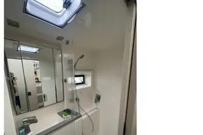 Modern bathroom in 2020 Leopard 40 yacht with skylight and sleek fixtures.