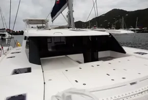 Leopard 50 catamaran, 2020 model, docked in a marina with scenic hillside background.