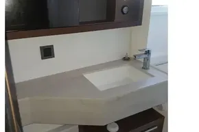 Modern bathroom sink in 2020 Lagoon 46 yacht, featuring sleek design and storage cabinets.