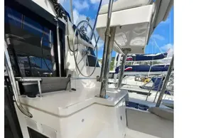 Leopard 50 yacht cockpit with steering wheel, modern design, and marina view, 2021 model.