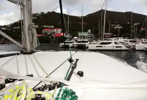 View from Leopard 50 yacht, docked in a marina with hills and buildings in the background.