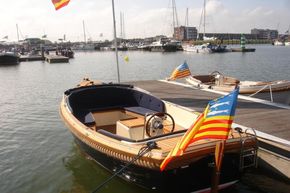 2026 Enkhuizensloep 615 boat docked at marina with colorful flags.