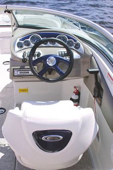 Crownline Deck Boat 240 EX - The helm features optional color-matched dash, tilt racing wheel and full instrumentation