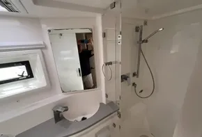 Modern bathroom interior of 2019 Leopard 51 Powercat yacht with shower and sink.