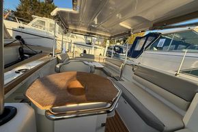 Interior of 2015 Alfastreet 23 boat with seating and wooden table.