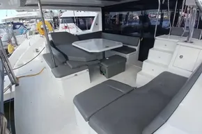 Spacious deck of 2022 Leopard 45 catamaran with seating and table.