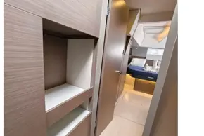 Modern interior of 2021 Leopard 50 yacht with sleek wood finishes and cozy bedroom.