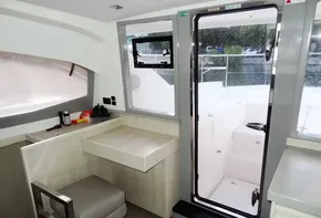 Interior of 2018 Leopard 43 Powercat with desk, chair, and door to deck.