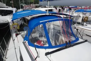 2017 Jeanneau Sun Odyssey 389 sailboat with blue canopy and clear windows.