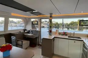 Luxurious interior of 2022 Leopard 42 catamaran with modern kitchen and scenic marina view.