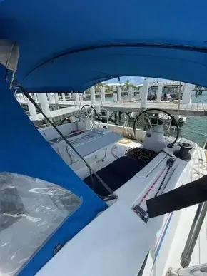 2017 Jeanneau Sun Odyssey 519 sailboat cockpit with blue canopy at marina.