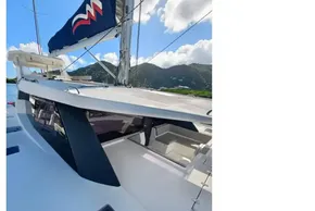 2021 Leopard 50 yacht with sleek design, docked near lush green hills under a blue sky.