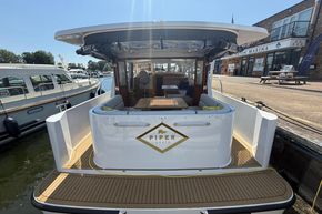 2024 Piper 12c boat docked at a marina, showcasing elegant design and spacious deck.