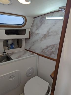 Brand new full size toilet in reconditioned large bathroom heads